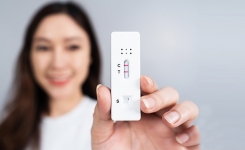 Lady holding antigen test